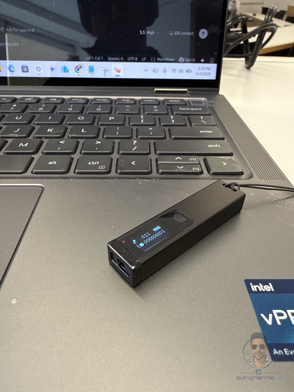 Small portable recorder on a laptop used to capture conversations for later transcription and AI analysis